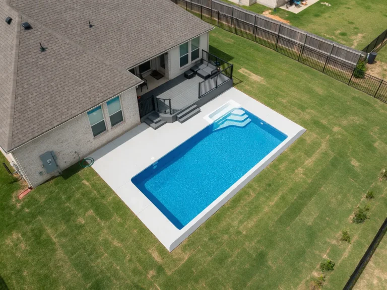 Aerial view of a backyard in-ground pool and deck