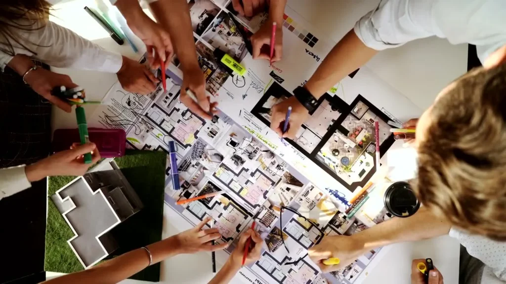 Design team reviewing printed floor plans together